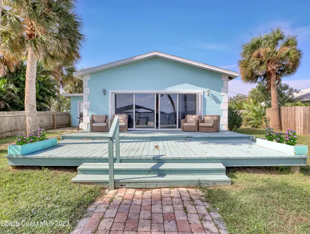 a view of a house with swimming pool and sitting area