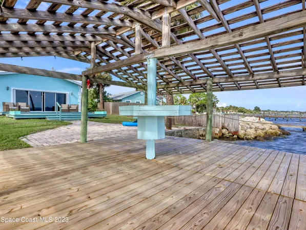 a view of a patio with a table and chairs