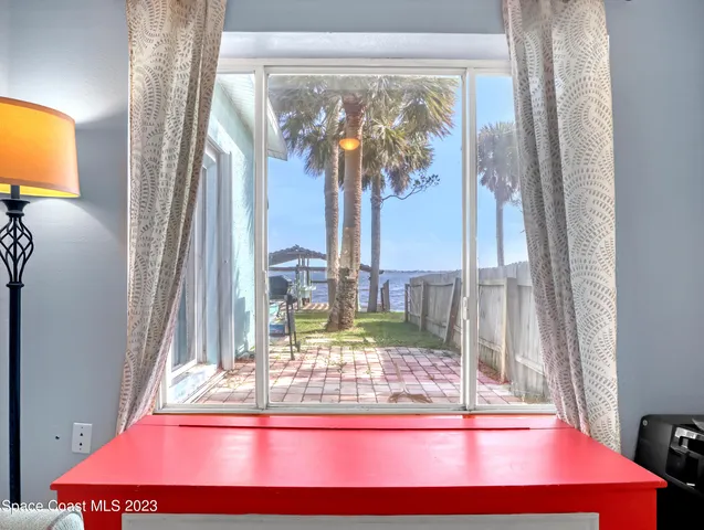 a view of a balcony with chair and floor to ceiling window