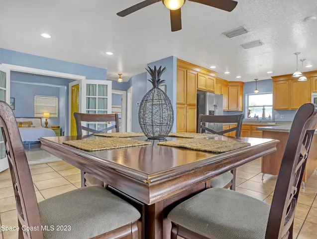 a view of a swimming pool kitchen from a dining room