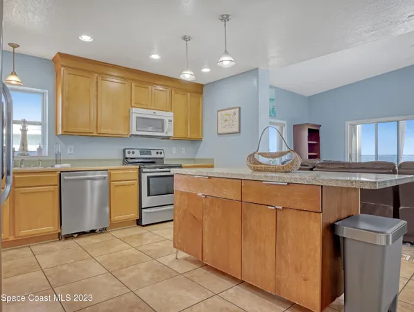 a kitchen with cabinets a sink and appliances