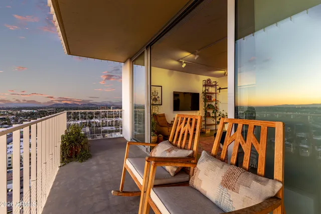 a balcony with chairs and wooden floor