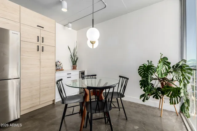 a view of a dining room with furniture and chandelier