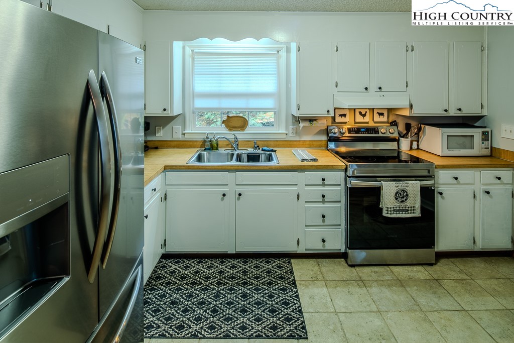 198 Black Pine Road Newland, NC 28657 - Photo 14 of 34 a kitchen with a sink stove and refrigerator