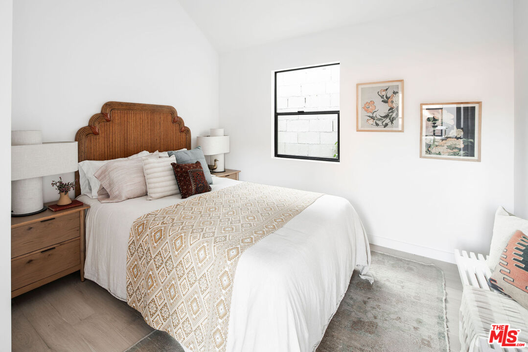 8550 Ridpath Drive Los Angeles, CA 90046 - Photo 13 of 32 a bedroom with a bed and painting on the wall