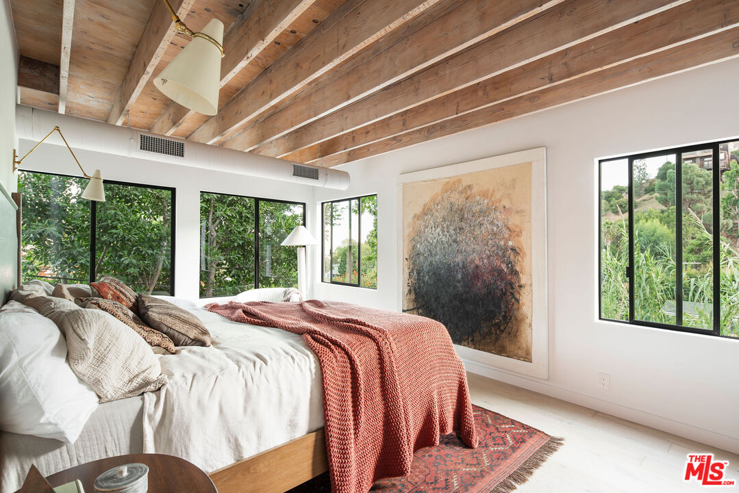 8550 Ridpath Drive Los Angeles, CA 90046 - Photo 19 of 32 a bed sitting in a bedroom next to a large window