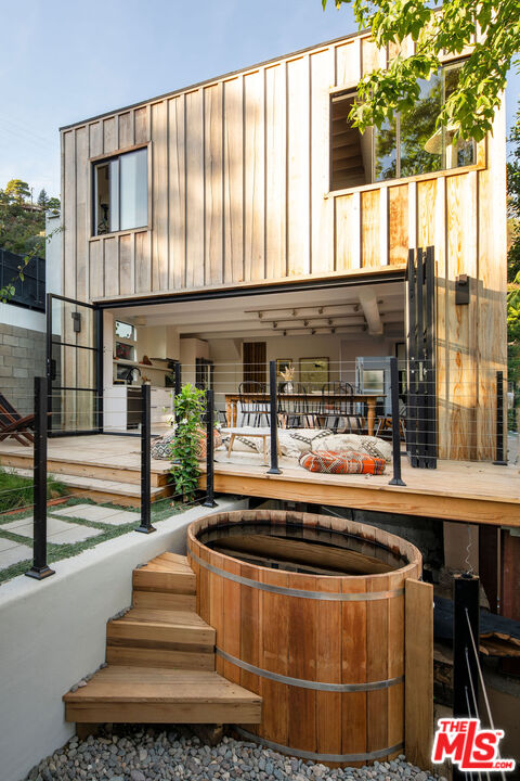 8550 Ridpath Drive Los Angeles, CA 90046 - Photo 26 of 32 a living room with a fireplace and large windows