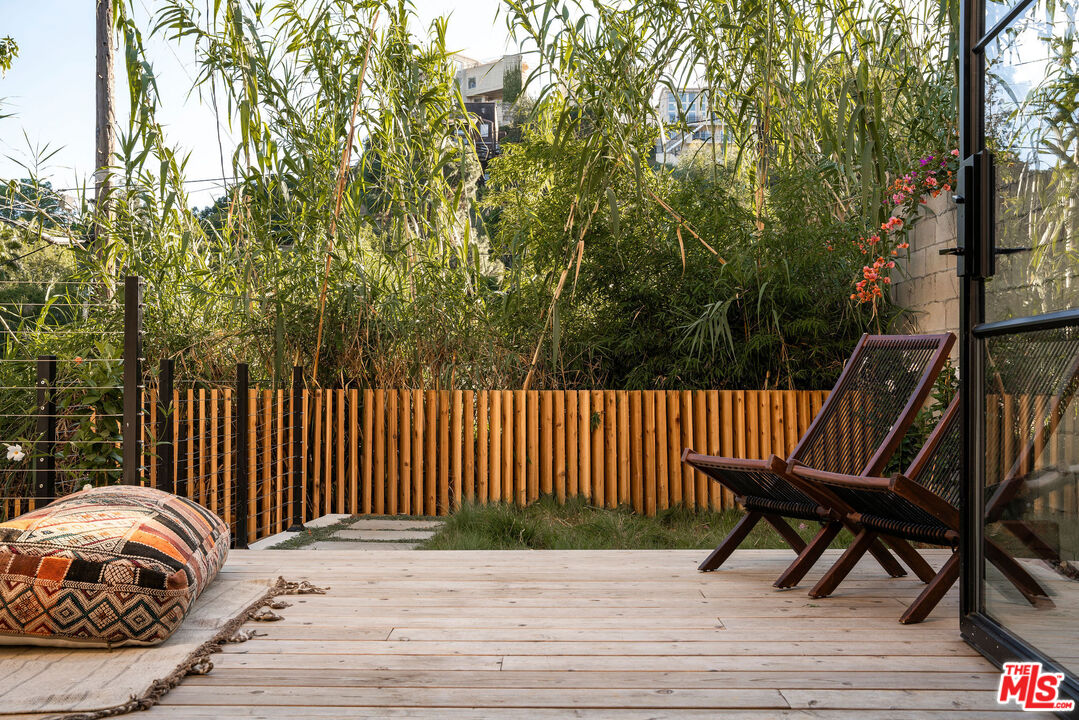 8550 Ridpath Drive Los Angeles, CA 90046 - Photo 27 of 32 a balcony with wooden floor table and chairs