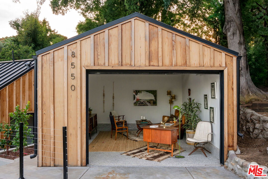 8550 Ridpath Drive Los Angeles, CA 90046 - Photo 30 of 32 a backyard of a house with outdoor seating and trees