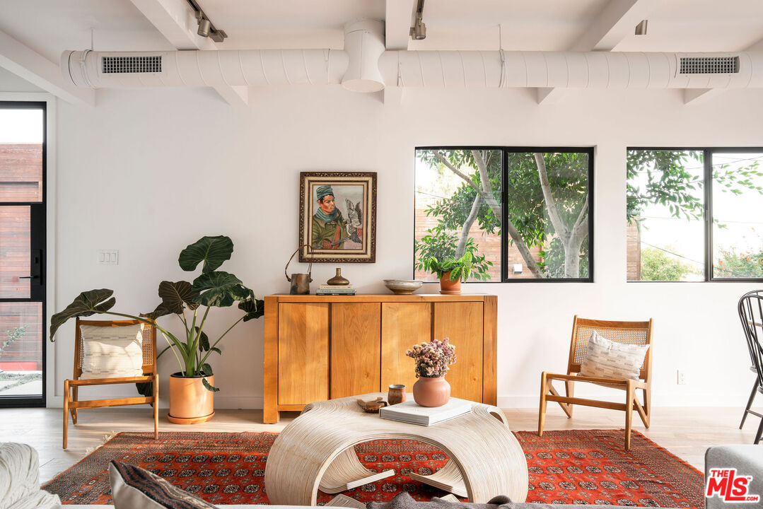 8550 Ridpath Drive Los Angeles, CA 90046 - Photo 4 of 32 a bedroom with a bed and wooden floor