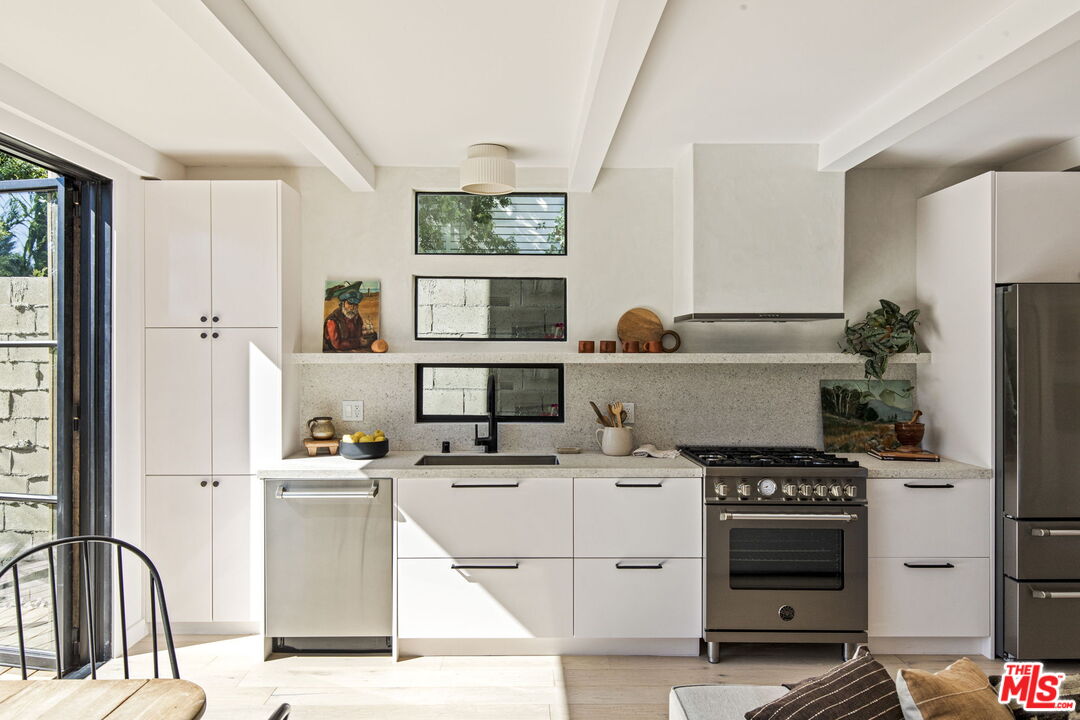 8550 Ridpath Drive Los Angeles, CA 90046 - Photo 9 of 32 a washing machine sitting inside of a kitchen