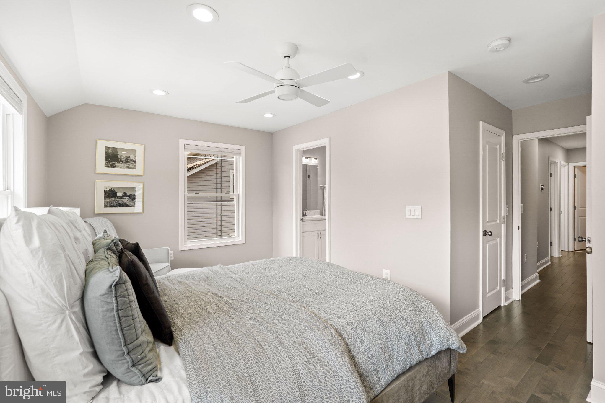 4416 Gault Place Northeast Washington, DC 20019 - Photo 17 of 30 a spacious bedroom with a bed and glass windows