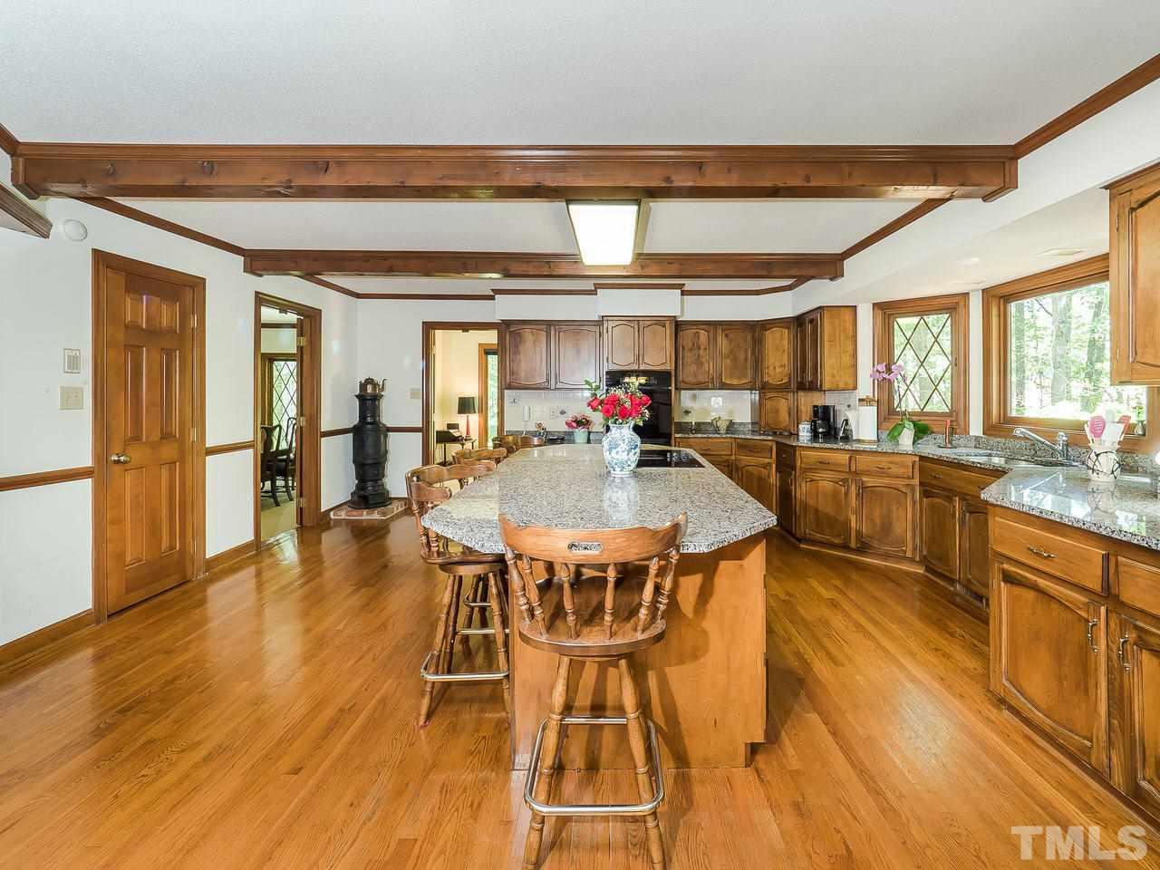 8857 Woodyhill Road Raleigh, NC 27613 - Photo 14 of 30 a view of a dining room with furniture and wooden floor