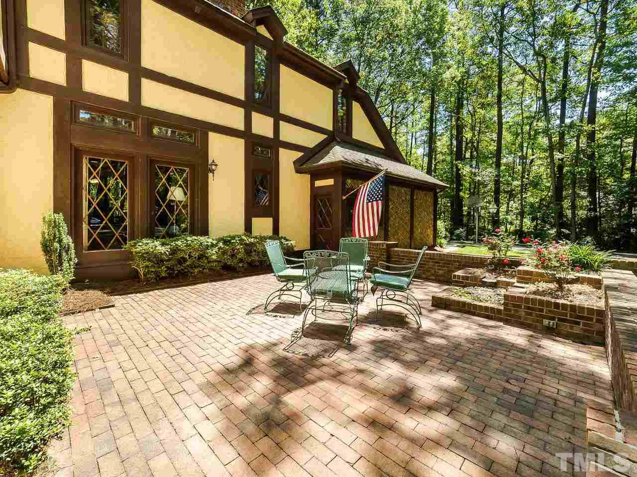 8857 Woodyhill Road Raleigh, NC 27613 - Photo 3 of 30 a view of a chair and tables in the patio