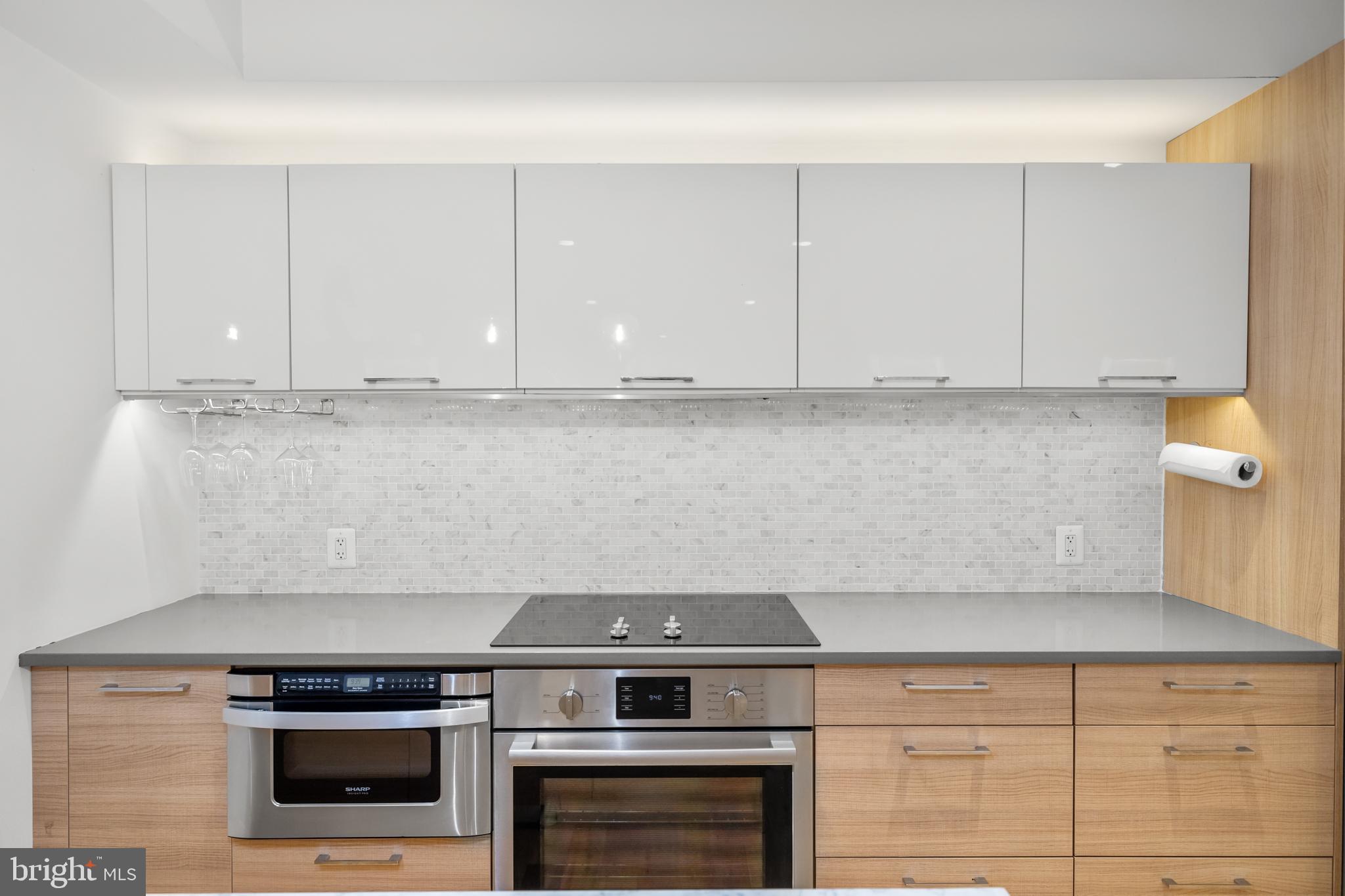 1324 W Street Northwest, Unit 1 Washington, DC 20009 - Photo 12 of 37 a stove top oven sitting inside of a kitchen