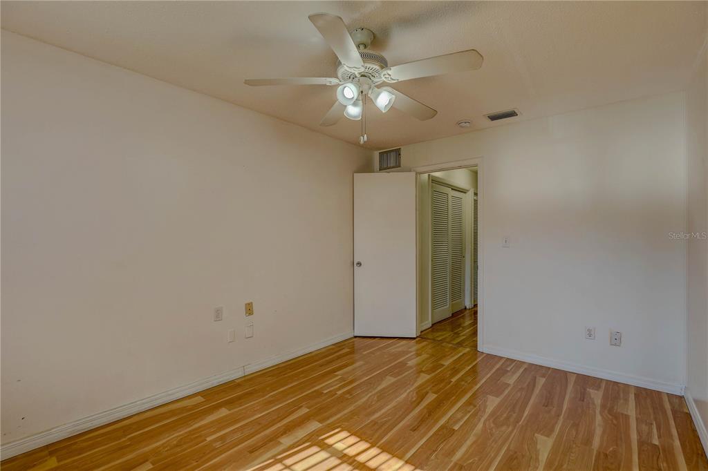 864 Lake Haven Road Dunedin, FL 34698 - Photo 11 of 28 wooden floor in an empty room