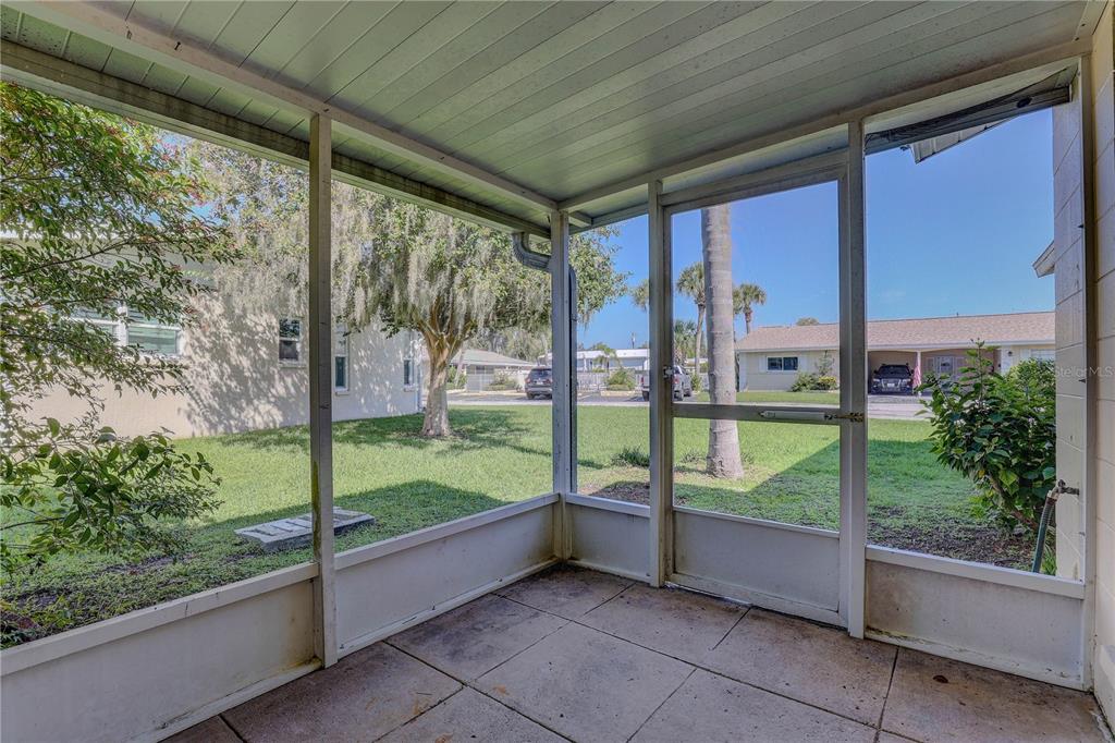 864 Lake Haven Road Dunedin, FL 34698 - Photo 18 of 28 a view of a porch with furniture and garden