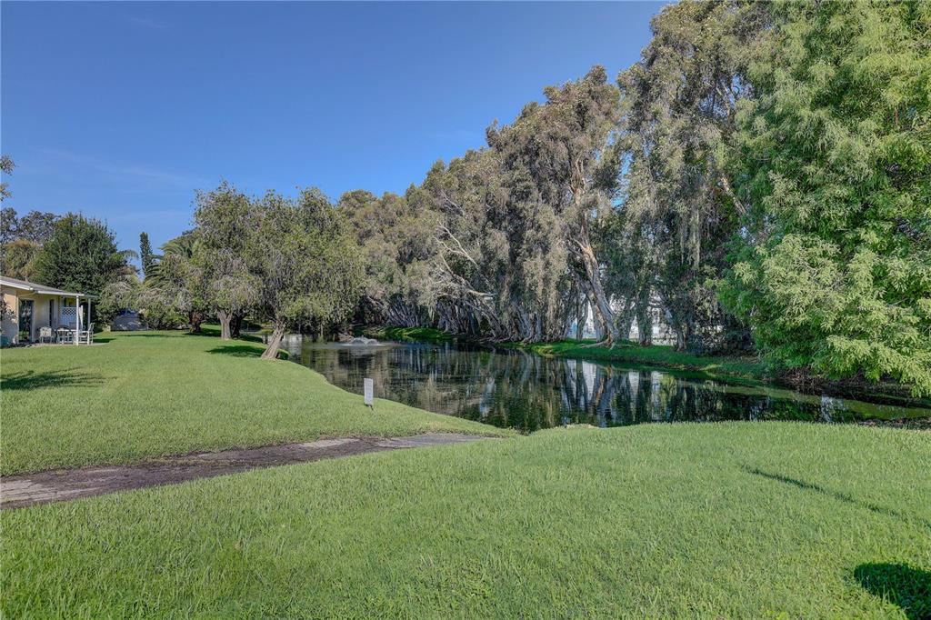 864 Lake Haven Road Dunedin, FL 34698 - Photo 23 of 28 a view of lake with a house in the background