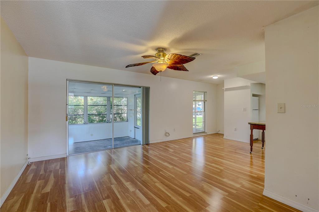 864 Lake Haven Road Dunedin, FL 34698 - Photo 5 of 28 a view of an empty room with window and wooden floor