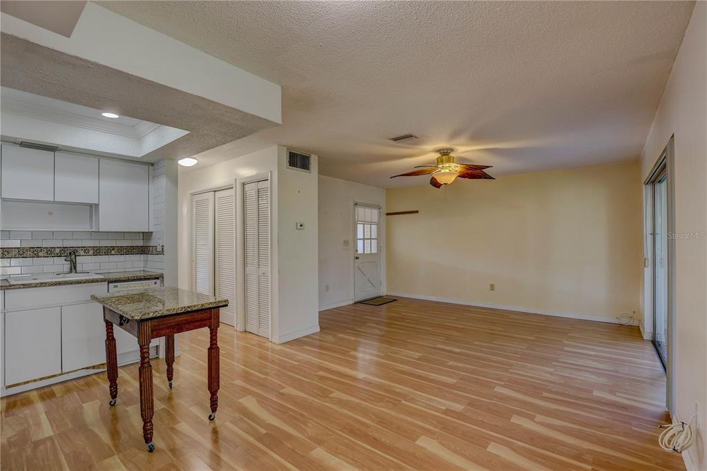 864 Lake Haven Road Dunedin, FL 34698 - Photo 6 of 28 a view of a kitchen with a sink dishwasher a refrigerator with wooden floor