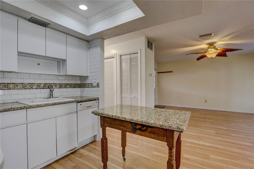 864 Lake Haven Road Dunedin, FL 34698 - Photo 8 of 28 a kitchen with a sink cabinets and wooden floor