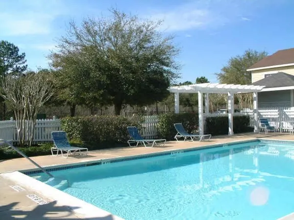 a swimming pool with outdoor seating and yard