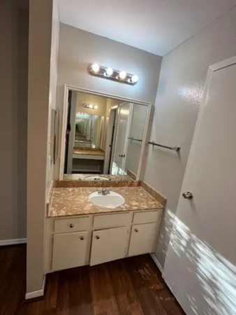 a bathroom with a granite countertop sink and a mirror