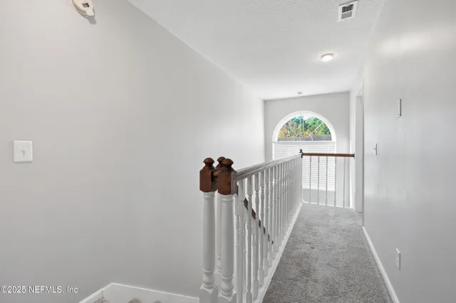 a view of a hallway with a window