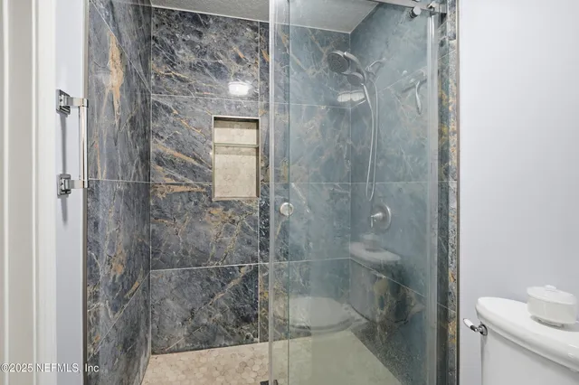 a bathroom with a shower and toilet