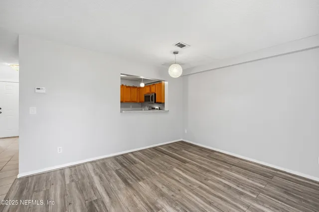 a view of room with wooden floor and fan