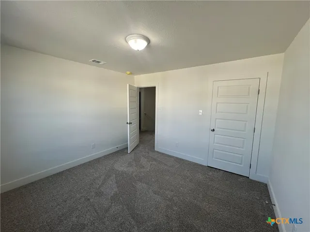 an empty room with closet area