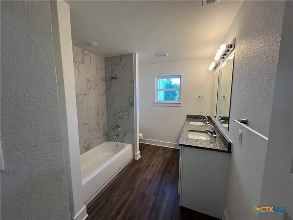 a bathroom with a sink a bathtub and a shower