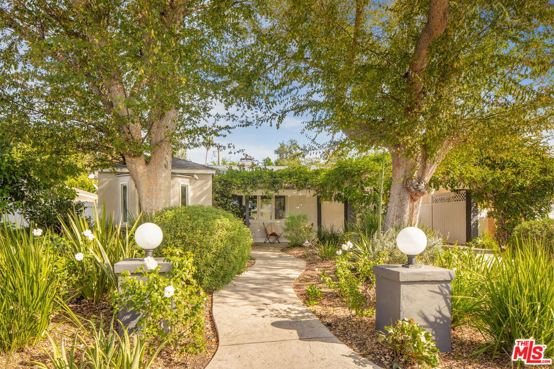 a view of a house with a yard and garden