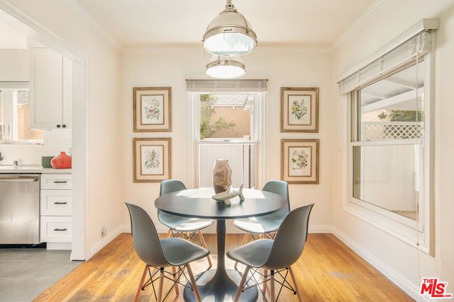 a view of living room with furniture and a refrigerator
