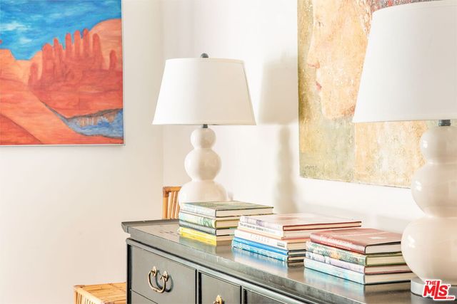 a bedroom with a bed a mirror and a large window