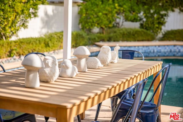 a view of a patio with table and chairs and potted plants