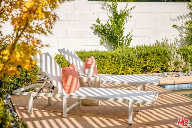a dinning table and chairs in patio of the house