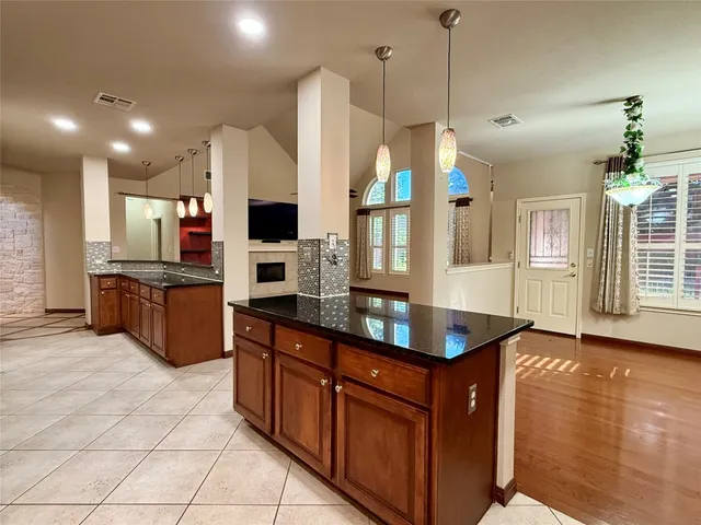 a kitchen with stainless steel appliances granite countertop a sink a stove and a refrigerator
