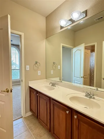 a bathroom with a double vanity sink and a mirror