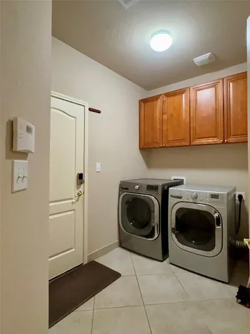 a utility room with sink dryer and washer