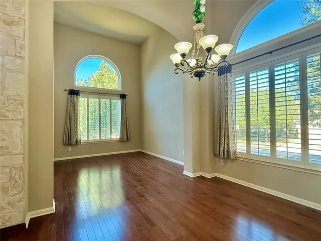 a view of a room with wooden floor and fan