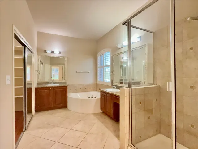 a large bathroom with a glass door shower sink and mirror