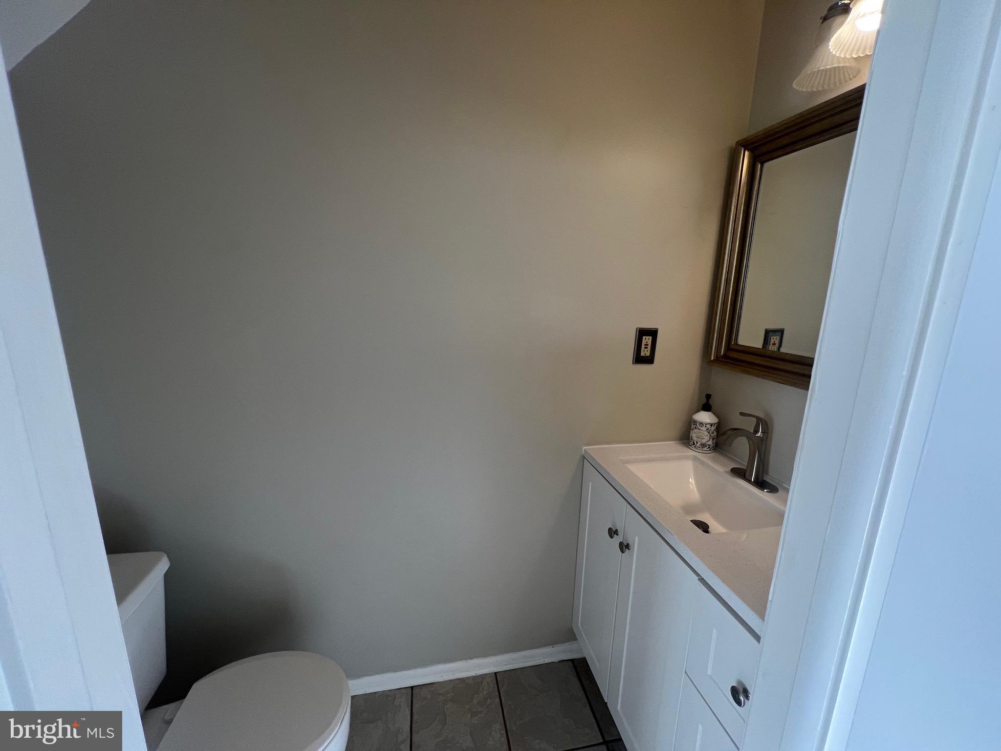 43 Taos Circle Middle River, MD 21220 - Photo 3 of 11 a bathroom with a sink toilet and mirror