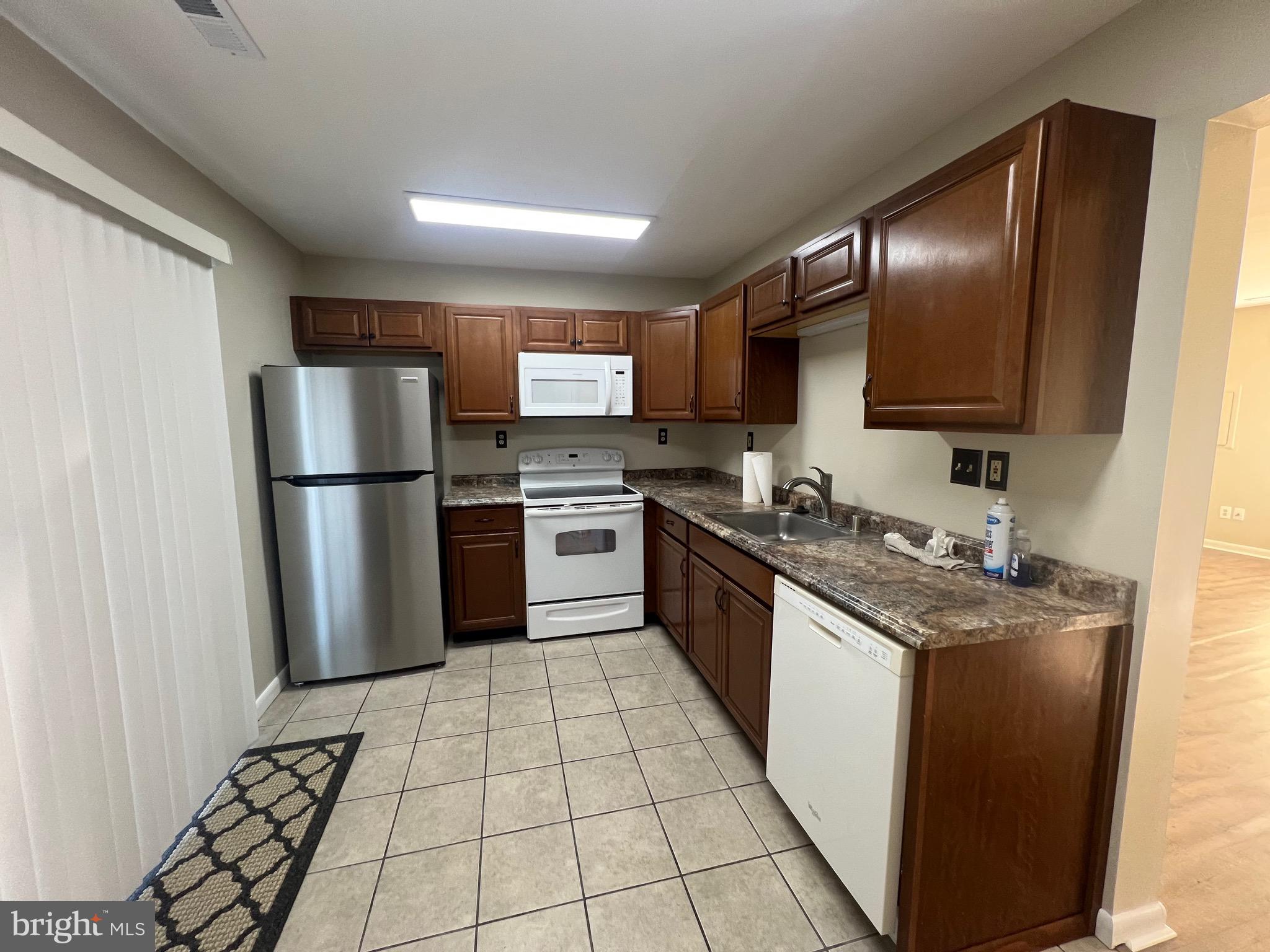 43 Taos Circle Middle River, MD 21220 - Photo 5 of 11 a kitchen with stainless steel appliances granite countertop a refrigerator a stove a sink dishwasher and a refrigerator