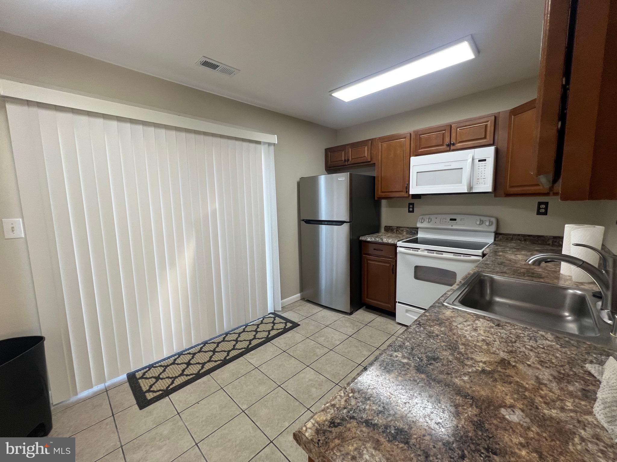43 Taos Circle Middle River, MD 21220 - Photo 7 of 11 a kitchen with granite countertop a refrigerator and a sink