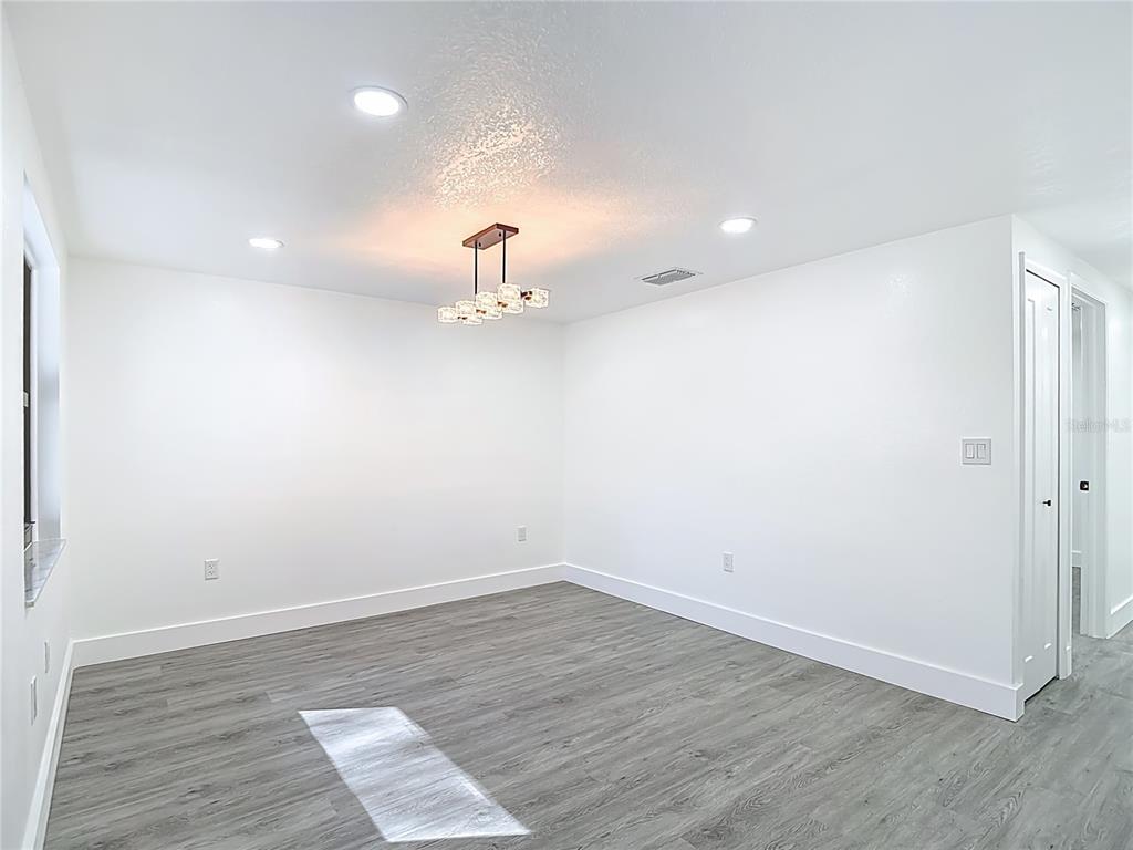 8130 San Felipe Court Port Richey, FL 34668 - Photo 12 of 54 a view of empty room with wooden floor