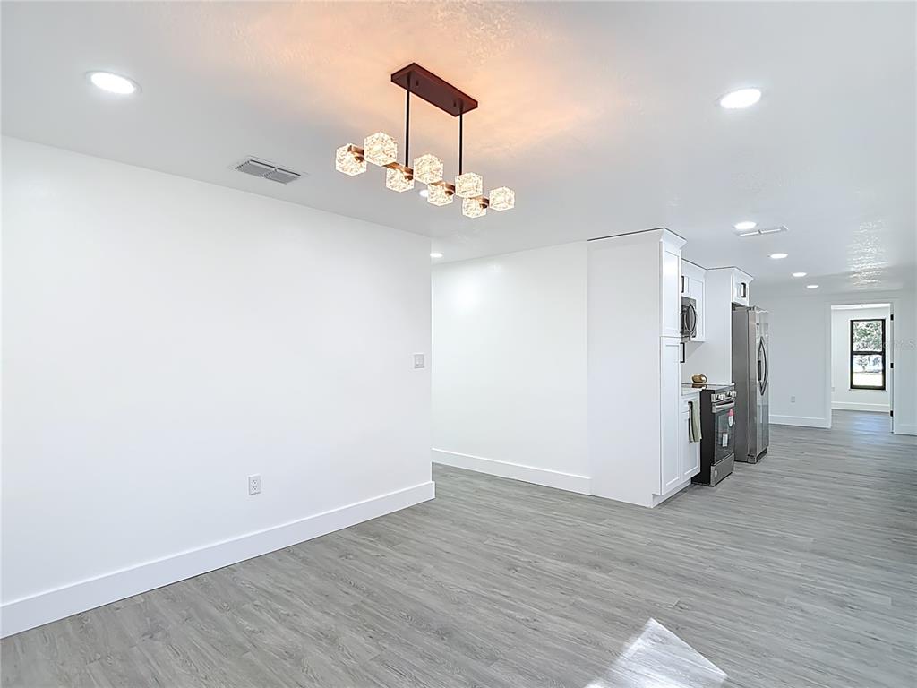 8130 San Felipe Court Port Richey, FL 34668 - Photo 15 of 54 a view of a kitchen with a sink and a wooden floor