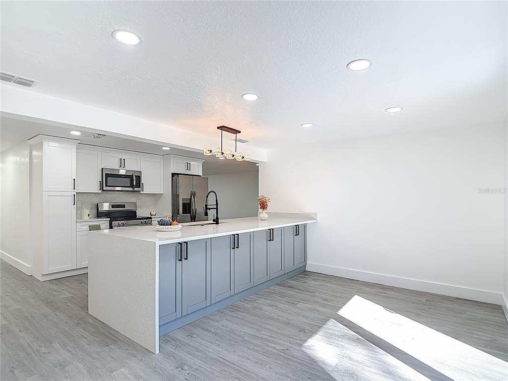 8130 San Felipe Court Port Richey, FL 34668 - Photo 17 of 54 a kitchen with cabinets a sink and wooden floor