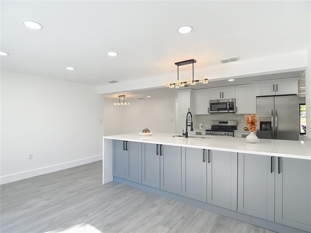 8130 San Felipe Court Port Richey, FL 34668 - Photo 18 of 54 a kitchen with stainless steel appliances a sink a stove a refrigerator and cabinets
