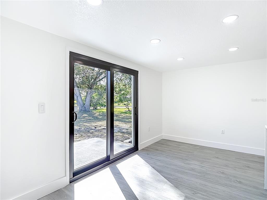 8130 San Felipe Court Port Richey, FL 34668 - Photo 19 of 54 a view of an empty room with wooden floor and a window